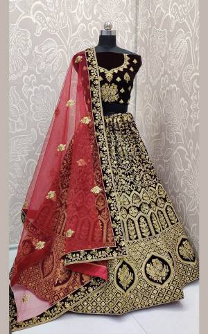 Here Is a Proper Heavy Traditional Lehenga Choli For The Upcoming Wedding Season In Dark Maroon Color Paired with A Very Pretty Red Colored Dupatta. This Heavy Embroidered Designer Lehenga Choli Is Fabricated On Velvet Paired With Net Fabricated Dupatta. Buy This Beautiful Traditional Piece Now.
