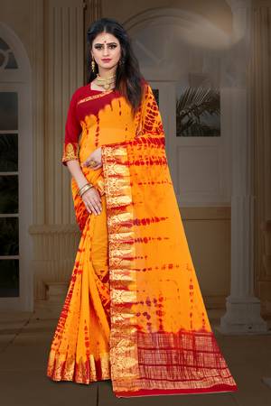 New And Unique Patterned Bandhani Printed Designer Saree In Musturd Yellow color Paired With Red colored Blouse. This Saree Is Fabricated On Chiffon Paired With Art Silk Fabricated Blouse. It Is Light In Weight And Easy To Carry All Day Long. 