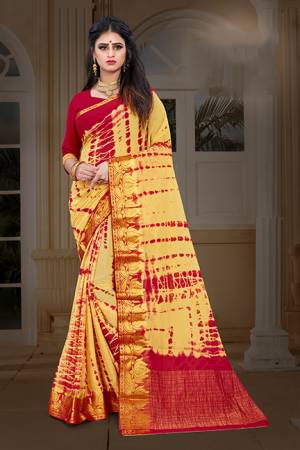 New And Unique Patterned Bandhani Printed Designer Saree In Light Yellow color Paired With Red colored Blouse. This Saree Is Fabricated On Chiffon Paired With Art Silk Fabricated Blouse. It Is Light In Weight And Easy To Carry All Day Long. 