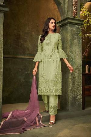 New And Unique Patterned Designer Suit Is Here In Light Green Colored Embroidered Top And Bottom Paired With Light Purple Colored Dupatta. Its Top and Dupatta are Net Based Paired With Santoon Fabricated Bottom. Its Pretty Top And Bottom Are Beautified With Detailed Tone To Tone Embroidery. Buy Now.