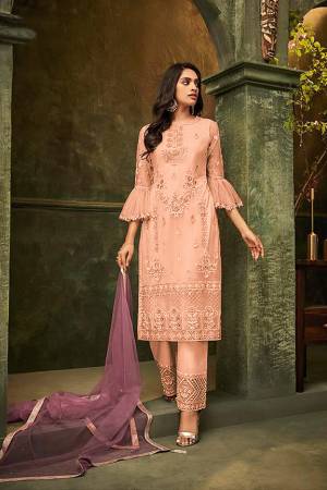 New And Unique Patterned Designer Suit Is Here In Peach Colored Embroidered Top And Bottom Paired With Light Purple Colored Dupatta. Its Top and Dupatta are Net Based Paired With Santoon Fabricated Bottom. Its Pretty Top And Bottom Are Beautified With Detailed Tone To Tone Embroidery. Buy Now.