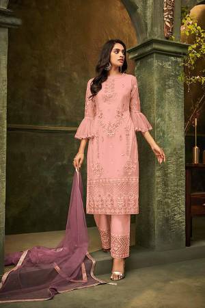 New And Unique Patterned Designer Suit Is Here In Pink Colored Embroidered Top And Bottom Paired With Light Purple Colored Dupatta. Its Top and Dupatta are Net Based Paired With Santoon Fabricated Bottom. Its Pretty Top And Bottom Are Beautified With Detailed Tone To Tone Embroidery. Buy Now.