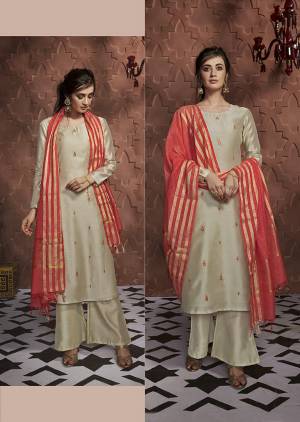 Flaunt Your Rich And Elegant Taste Wearing This Designer Readymade Suit In Cream Color Paired With Orange Colored Dupatta. This Pretty Readymade Top And Plazzo Are Soft Silk Based Paired With Banarasi Silk Dupatta. 