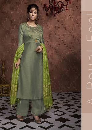 Go With The Shades Of Green With This Readymade Suit In Olive Green Color Paired With Parrot Green Colored Dupatta. This Suit Is Fabricated On Soft Silk Paired With Banarasi Silk Fabricated Dupatta. 