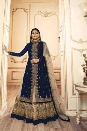 Grab This Beautiful And Heavy Designer Suit With Two Bottoms In Navy Blue And Cream Color. Its Embroidered Top Is Fabricated Georgette Satin Paired With One Santoon Plain Bottom And Another Embroidered Lehenga Is Fabricated On Net Paired With Net Fabricated Dupatta. Its Rich Color Pallete And Detailed Embroidery Will Eanr You Lots Of Compliments From Onlookers. 