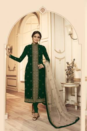 Grab This Beautiful And Heavy Designer Suit With Two Bottoms In Dark Green And Cream Color. Its Embroidered Top Is Fabricated Georgette Satin Paired With One Santoon Plain Bottom And Another Embroidered Lehenga Is Fabricated On Net Paired With Net Fabricated Dupatta. Its Rich Color Pallete And Detailed Embroidery Will Eanr You Lots Of Compliments From Onlookers. 
