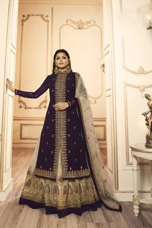 Grab This Beautiful And Heavy Designer Suit With Two Bottoms In Dark Purple And Cream Color. Its Embroidered Top Is Fabricated Georgette Satin Paired With One Santoon Plain Bottom And Another Embroidered Lehenga Is Fabricated On Georgette Paired With Georgette Fabricated Dupatta. Its Rich Color Pallete And Detailed Embroidery Will Eanr You Lots Of Compliments From Onlookers. 