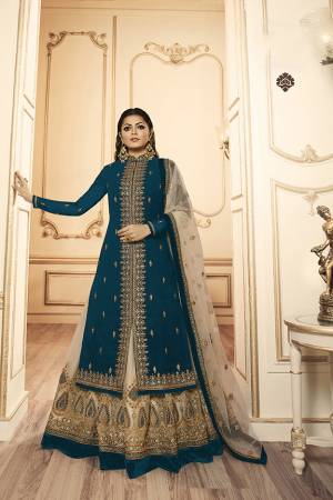 Grab This Beautiful And Heavy Designer Suit With Two Bottoms In Teal Blue And Cream Color. Its Embroidered Top Is Fabricated Georgette Satin Paired With One Santoon Plain Bottom And Another Embroidered Lehenga Is Fabricated On Georgette Paired With Georgette Fabricated Dupatta. Its Rich Color Pallete And Detailed Embroidery Will Eanr You Lots Of Compliments From Onlookers. 