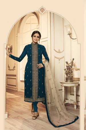 Grab This Beautiful And Heavy Designer Suit With Two Bottoms In Teal Blue And Cream Color. Its Embroidered Top Is Fabricated Georgette Satin Paired With One Santoon Plain Bottom And Another Embroidered Lehenga Is Fabricated On Georgette Paired With Georgette Fabricated Dupatta. Its Rich Color Pallete And Detailed Embroidery Will Eanr You Lots Of Compliments From Onlookers. 