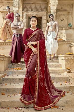 Here Is A Royal Looking Designer Saree In Maroon Color. This Saree Is Fabricated On Lycra And Net Paired With Art Silk Fabricated Blouse. Its Fabric Is Durable And Easy To Care For. It Lovely Tone To Tone Embroidery Gives A Subtle Look To The Saree. 