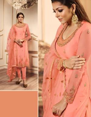 A Must Have Shade In Every Womens Wardrobe Is Here With This Designer Indo-Western Suit In Peach Color Which Comes With Two Bottom. Its pretty Embroidered Top, Lehenga And Dupatta are Net Based Paired With A Santoon Fabricated Bottom. 