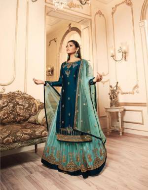 Pretty Shades Of Blue Are Here With This Designer Heavy Indo-Western Suit In Navy Blue And Sky Blue Color. Its Top IS Fabricated On Satin Georgette Paired With Two Bottoms, One In Santoon And Another In Net Fabricated Lehenga And Net Dupatta. All Its Fabric Are Durable, Light Weight And Easy To Carry All Day Long. 