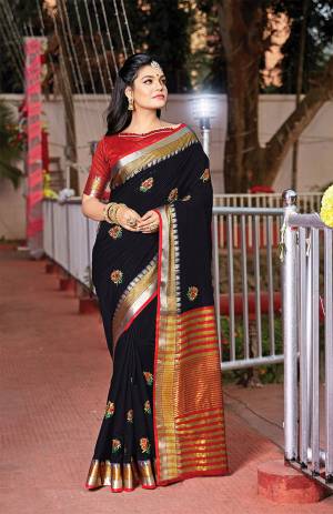 For Your Semi-Casuals, Grab This Saree In Black Color Paired With Red Colored Blouse. This Saree And Blouse Are Fabricated On Handloom Cotton Which Is Durable, Light Weight And Easy To Carry All Day Long. 