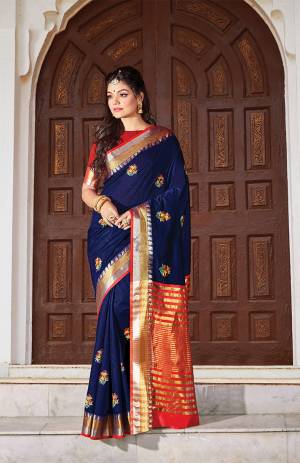 For Your Semi-Casuals, Grab This Saree In Navy Blue Color Paired With Red Colored Blouse. This Saree And Blouse Are Fabricated On Handloom Cotton Which Is Durable, Light Weight And Easy To Carry All Day Long. 