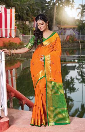 For Your Semi-Casuals, Grab This Saree In Orange Color Paired With Green Colored Blouse. This Saree And Blouse Are Fabricated On Handloom Cotton Which Is Durable, Light Weight And Easy To Carry All Day Long. 