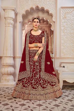 Get Ready For Your D-Day With This Heavy Designer Lehenga Choli In?All Over Maroon Color. This Heavy Embroidered Lehenga Choli Is Fabricated On Velvet Paired With Net Fabricated Dupatta. It Is Beautified With Heavy Coding Jari Embroidery. Buy This Bridal Lehenga Now.