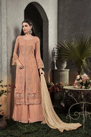 Here Is A Very Beautiful Designer Straight Suit In Pretty Peach Color Paired With Cream Colored Dupatta. Its Pretty Embroidered Top And Bottom Are Fabricated On Georgette Paired With Chiffon Fabricated Dupatta. It Is Light In Weight And Easy To Carry All Day Long. 