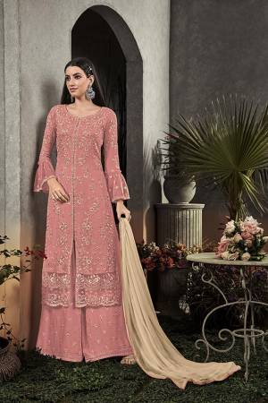 Here Is A Very Beautiful Designer Straight Suit In Pretty Pink Color Paired With Cream Colored Dupatta. Its Pretty Embroidered Top And Bottom Are Fabricated On Georgette Paired With Chiffon Fabricated Dupatta. It Is Light In Weight And Easy To Carry All Day Long. 