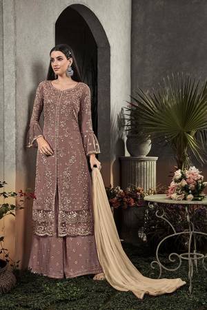 Here Is A Very Beautiful Designer Straight Suit In Pretty Mauve Color Paired With Cream Colored Dupatta. Its Pretty Embroidered Top And Bottom Are Fabricated On Georgette Paired With Chiffon Fabricated Dupatta. It Is Light In Weight And Easy To Carry All Day Long. 