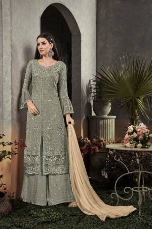 Here Is A Very Beautiful Designer Straight Suit In Pretty Teal Grey Color Paired With Cream Colored Dupatta. Its Pretty Embroidered Top And Bottom Are Fabricated On Georgette Paired With Chiffon Fabricated Dupatta. It Is Light In Weight And Easy To Carry All Day Long. 