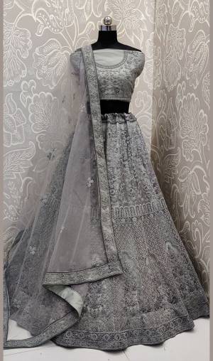 Very Beautiful And Heavy Embroidered Lehenga Choli Is Here In Grey Color With Detailed Tone-To-Tone Embroidery All Over. This Heavy Embroidered Lehenga Choli Is Fabricated On Net. Its Fabric Ensures Superb Comfort Throughout The Gala. Buy Now.