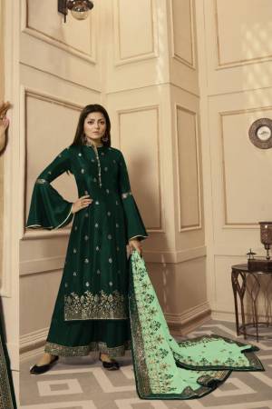 Get Ready For The Upcoming Festive And Wedding Season With This Very Beautiful Designer Straight Suit In Dark Green Color Paired With Light Green Colored Dupatta. Its Embroidered Top Is Satin Georgette Based Paired With Santoon Bottom And Net Fabricated Heavy Embroidered Dupatta. Buy This Lovely Suit Now.