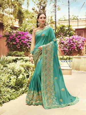 Here Is A Very Beautiful Heavy Designer Saree In Sea Green Color Paired With Cream Colored Blouse. This Saree And Blouse are Silk Based Beautified With Heavy Embroidery Which also Gives A Rich Look To Your Personality.