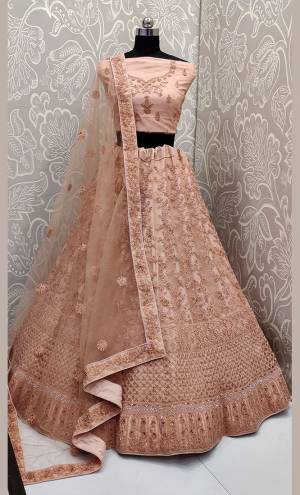 This Wedding Season, Look The Most Graceful Of All Wearing This Heavy Designer Elegant Lehenga Choli In Peach Color. Its Blouse, Lehenga And Dupatta are Fabricated on Net Beautified With Tone To Tone Coding And Resham Embroidery With Stone Work. Its Pretty Elegant Color And Tone-To-Tone Work Will Definitely Earn You Lots Of Compliments From Onlookers. 