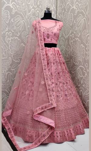 This Wedding Season, Look The Most Graceful Of All Wearing This Heavy Designer Elegant Lehenga Choli In Pink Color. Its Blouse, Lehenga And Dupatta are Fabricated on Net Beautified With Tone To Tone Coding And Resham Embroidery With Stone Work. Its Pretty Elegant Color And Tone-To-Tone Work Will Definitely Earn You Lots Of Compliments From Onlookers. 