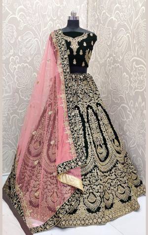 Here Is A Beautiful Designer Bridal Lehenga Choli In Dark Green?Color Paired With Baby Pink Colored Dupatta. This Beautiful Heavy Lehenga Choli Is Fabricated On Velvet Paired With Net Fabricated Dupatta. It Is Beautified With Heavy Detailed Embroidery. Get Ready For Your D-Day With This Designer Piece And Look The Most Graceful Of All.?