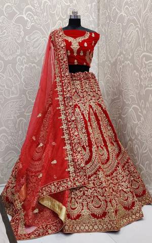 Here Is A Beautiful Designer Bridal Lehenga Choli In Red Color. This Beautiful Heavy Lehenga Choli Is Fabricated On Velvet Paired With Net Fabricated Dupatta. It Is Beautified With Heavy Detailed Embroidery. Get Ready For Your D-Day With This Designer Piece And Look The Most Graceful Of All.