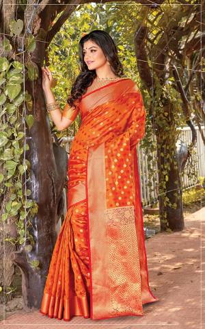 Celebrate This Festive Season Wearing This Designer Saree In Orange Color. This Saree Is Fabricated On Cotton Silk Paired With Jacquard Silk Fabricated Blouse Beautified With Weave.
