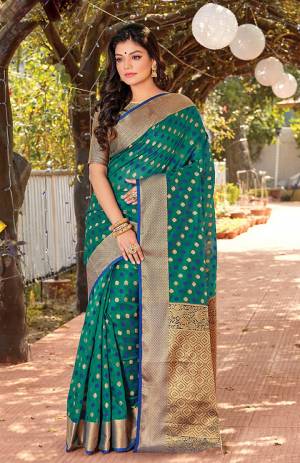 Celebrate This Festive Season Wearing This Designer Saree In Teal Green Color. This Saree Is Fabricated On Cotton Silk Paired With Jacquard Silk Fabricated Blouse Beautified With Weave.