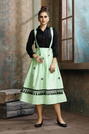 Grab This Pretty Two-Piece Readymade Dress Which Has A Black Colored Shirt Paired With A Dungaree Dress In Light Green Color. The Shirt Is Fabricated on Rayon Paired With Cotton Based Over Dress. It Is Light In Weight And Easy To Carry All Day Long. 