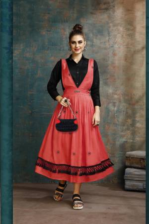 Grab This Pretty Two-Piece Readymade Dress Which Has A Black Colored Shirt Paired With A Dungaree Dress In Red Color. The Shirt Is Fabricated on Rayon Paired With Cotton Based Over Dress. It Is Light In Weight And Easy To Carry All Day Long. 