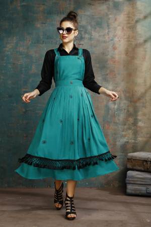 Grab This Pretty Two-Piece Readymade Dress Which Has A Black Colored Shirt Paired With A Dungaree Dress In Teal Blue Color. The Shirt Is Fabricated on Rayon Paired With Cotton Based Over Dress. It Is Light In Weight And Easy To Carry All Day Long. 