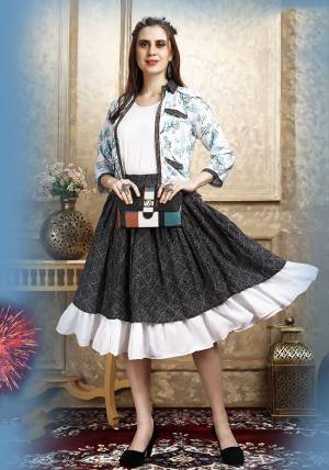 Here Is A Pretty Three Piece Western Set In White Colored Top Paired With Blue Colored Skirt And White Colored Printed Jacket. Its Top Is Fabricated on Cotton Lycra Paired With Rayon Fabricated Skirt and Jacket. 