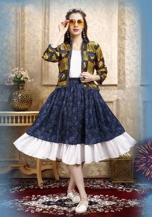 Here Is A Pretty Three Piece Western Set In White Colored Top Paired With Blue Colored Skirt And Yellow Colored Printed Jacket. Its Top Is Fabricated on Cotton Lycra Paired With Rayon Fabricated Skirt and Jacket. 