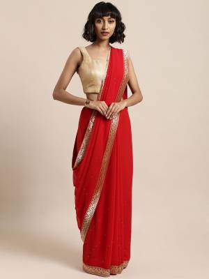 Add This Pretty Elegant Looking Saree To Your Wardrobe In Red Color Paired With Red Colored Blouse. This Saree Is Fabricated On Georgette Paired With Art Silk Fabricated Blouse. It Is Beautified With Jacquard Lace Border And Stone Work. Buy Now.