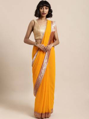 Celebrate This Festive Season In This Pretty Saree In Yellow Color Paired With Red Colored Blouse, This Pretty Saree Is Georgette Based Paired With Art Silk Fabricated Blouse. It Is Light In Weight And Easy To Carry All Day Long. 