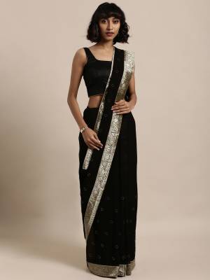 Add This Pretty Elegant Looking Saree To Your Wardrobe In Black Color Paired With Black Colored Blouse. This Saree Is Fabricated On Georgette Paired With Art Silk Fabricated Blouse. It Is Beautified With Jacquard Lace Border And Stone Work. Buy Now.