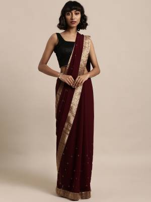Add This Pretty Elegant Looking Saree To Your Wardrobe In Maroon Color Paired With Maroon Colored Blouse. This Saree Is Fabricated On Georgette Paired With Art Silk Fabricated Blouse. It Is Beautified With Jacquard Lace Border And Stone Work. Buy Now.