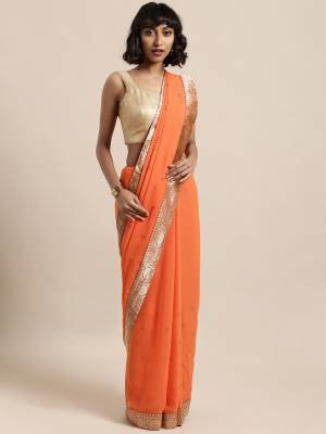 Celebrate This Festive Season In This Pretty Saree In Orange Color Paired With Red Colored Blouse, This Pretty Saree Is Georgette Based Paired With Art Silk Fabricated Blouse. It Is Light In Weight And Easy To Carry All Day Long. 