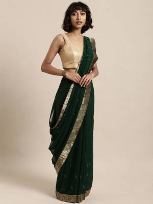 Add This Pretty Elegant Looking Saree To Your Wardrobe In Pine Green Color Paired With Pine Green Colored Blouse. This Saree Is Fabricated On Georgette Paired With Art Silk Fabricated Blouse. It Is Beautified With Jacquard Lace Border And Stone Work. Buy Now.