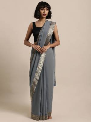 Celebrate This Festive Season In This Pretty Saree In Grey Color Paired With Grey Colored Blouse, This Pretty Saree Is Georgette Based Paired With Art Silk Fabricated Blouse. It Is Light In Weight And Easy To Carry All Day Long. 