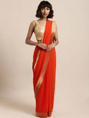 Add This Pretty Elegant Looking Saree To Your Wardrobe In Orange Color Paired With Red Colored Blouse. This Saree Is Fabricated On Georgette Paired With Art Silk Fabricated Blouse. It Is Beautified With Jacquard Lace Border And Stone Work. Buy Now.
