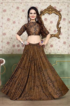 Grab This Beautiful Pair Of Lehenga Choli In Brown Color Fabricated On Lycra. It Has Fully Stitched Lehenga And Unstitched Blouse. Also It Is Beautified With Foil Print Giving It An Attractive Look. Buy Now.