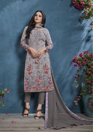 Here Is A Beautiful Shade To Add Into Your Wardrobe With This Designer Straight Suit In Grey Color. Its Tone To Tone Embroidered Top Is Cotton Based Paired With Santoon Bottom and Chiffon Fabricated Dupatta. 