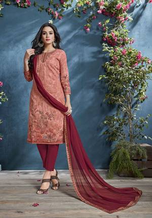 Look Pretty In Wearing This Lovely Semi-Stitched Suit In Dark Peach Color Paired With Maroon Colored Bottom And Dupatta. Its Top IS Fabricated On Cotton Beautified With Prints And Tone To Tone Resham Work Paired With Santoon Bottom And Chiffon fabricated Dupatta. Buy Now.