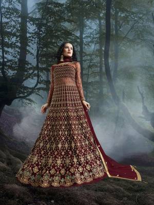 Grab This Heavy Designer Floor Length Suit In Maroon Color For The Upcoming Wedding Season. This Very Beautiful And Heavy Embroidered Floor Length Top Is Fabricated On Net Paired With Silk based Bottom And Net Fabricated Dupatta. Its Detailed Embroidery With Perfect Color Combination Will Earn You Lots Of Compliments From Onlookers.